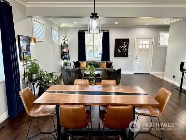 dining area with crown molding and dark hardwood / wood-style floors