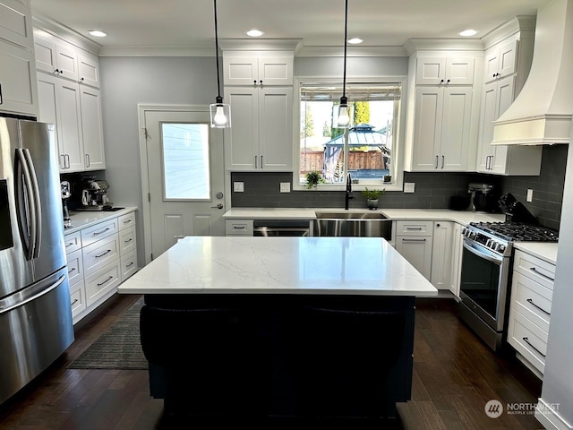 kitchen featuring premium range hood, stainless steel appliances, a center island, and pendant lighting