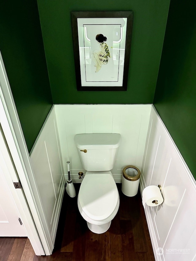 bathroom with hardwood / wood-style flooring and toilet