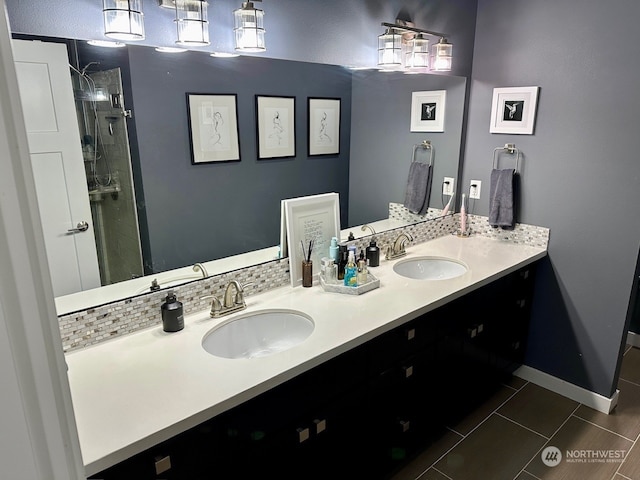 bathroom featuring backsplash, vanity, and a tile shower