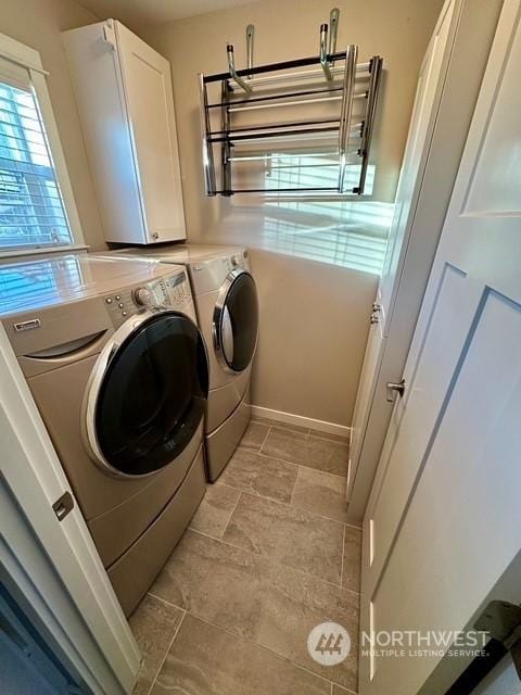 washroom featuring cabinets and washing machine and dryer