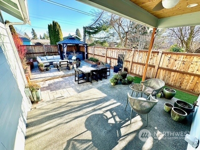 view of patio with a gazebo, an outdoor hangout area, and ceiling fan