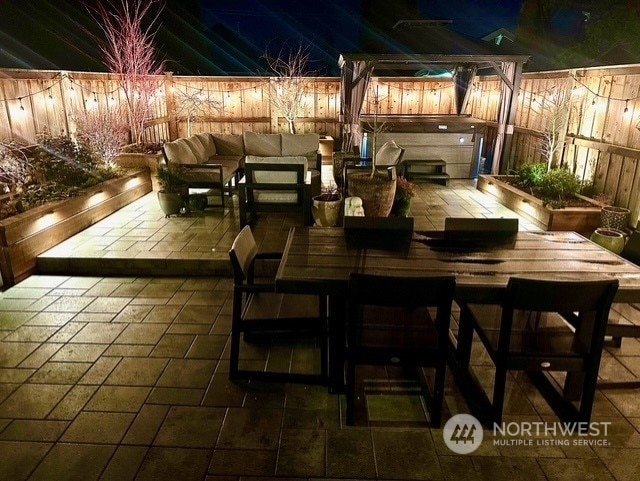 view of patio / terrace featuring a hot tub and outdoor lounge area