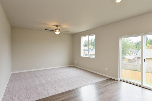 unfurnished room with ceiling fan and light wood-type flooring