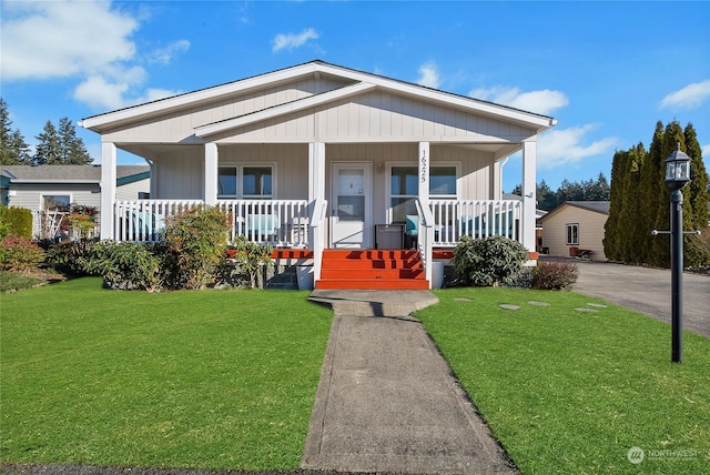 view of front of house with covered porch and a front yard