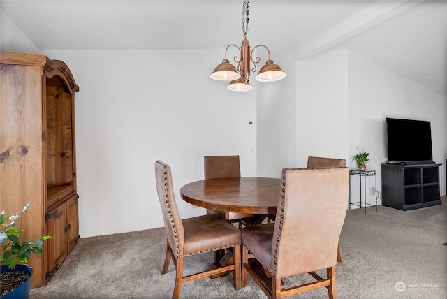 carpeted dining space with lofted ceiling and a chandelier