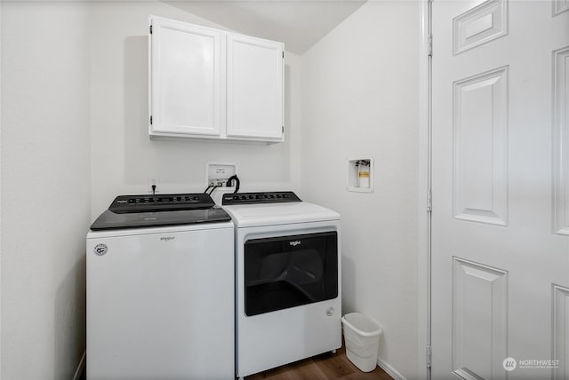 laundry area featuring dark wood-type flooring, cabinets, and washing machine and clothes dryer