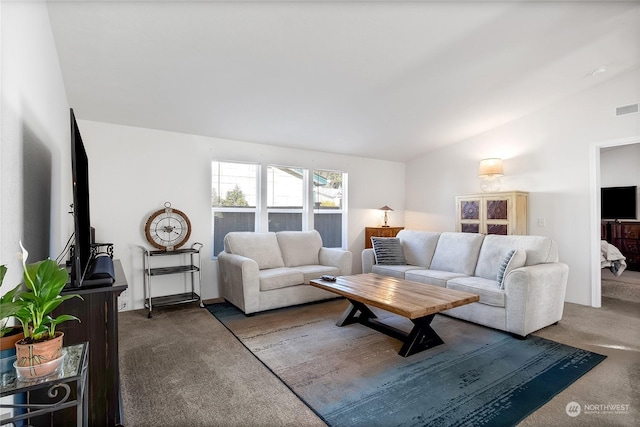 living room with vaulted ceiling and dark colored carpet