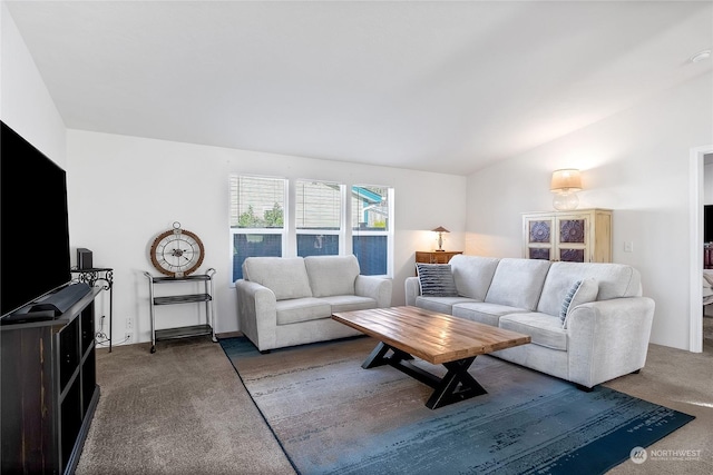 living room with lofted ceiling and dark carpet