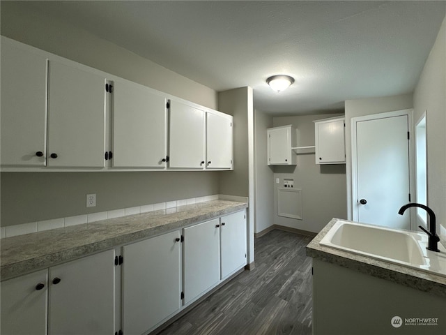 kitchen featuring white cabinetry, sink, and dark hardwood / wood-style floors