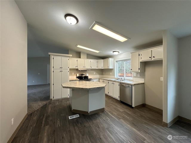 kitchen with white cabinetry, lofted ceiling, a center island, and appliances with stainless steel finishes