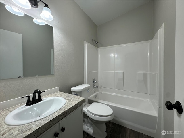 full bathroom featuring vanity, wood-type flooring, bathtub / shower combination, and toilet