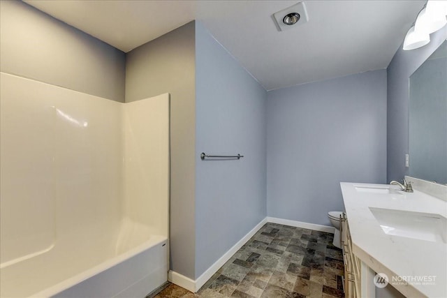 full bathroom featuring vanity, bathing tub / shower combination, and toilet