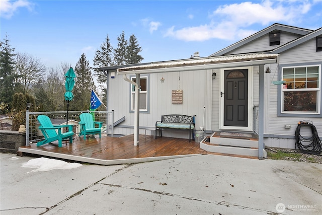 exterior space featuring a wooden deck and a patio area