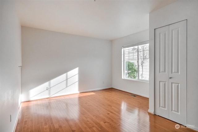 spare room with light wood-type flooring