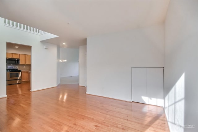 interior space with light hardwood / wood-style floors and a notable chandelier