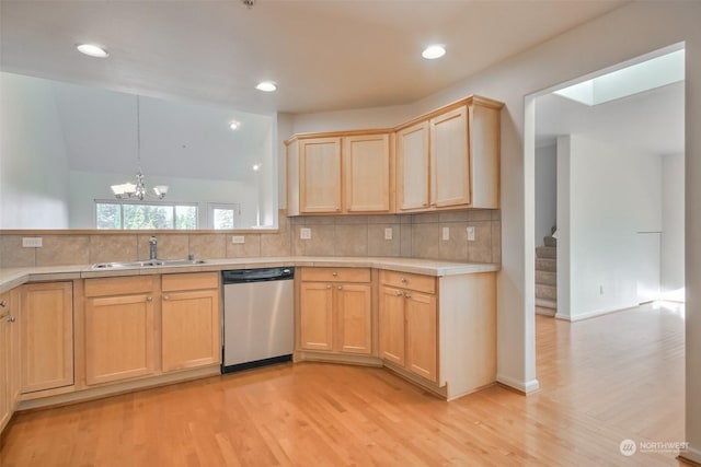 kitchen featuring sink, dishwasher, tasteful backsplash, light hardwood / wood-style floors, and decorative light fixtures