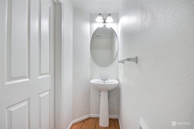 bathroom with wood-type flooring and sink