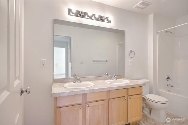 full bathroom with shower / tub combination, vanity, toilet, and tile patterned floors