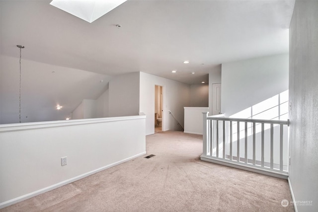 empty room with light carpet and a skylight