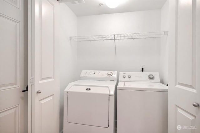 laundry area featuring washing machine and clothes dryer