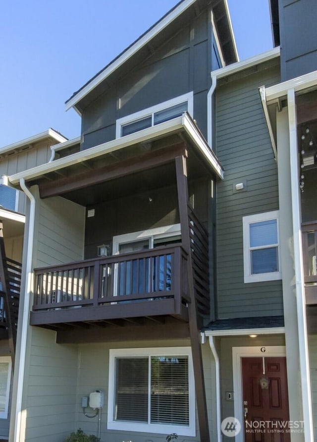 back of property featuring a balcony