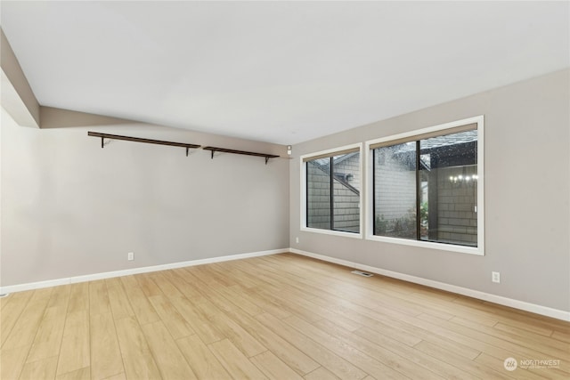 unfurnished room with light wood-type flooring