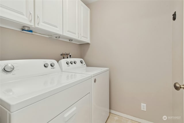 washroom with cabinets and washing machine and dryer