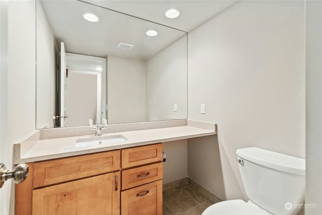 bathroom featuring vanity, toilet, and tile patterned flooring