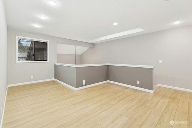 basement with hardwood / wood-style floors