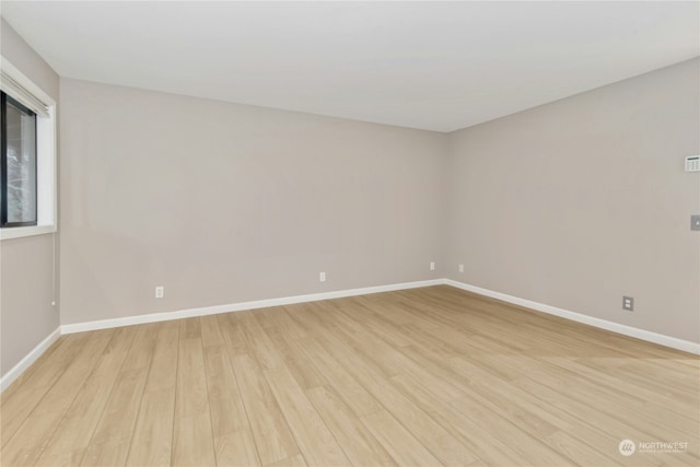 spare room with light hardwood / wood-style floors