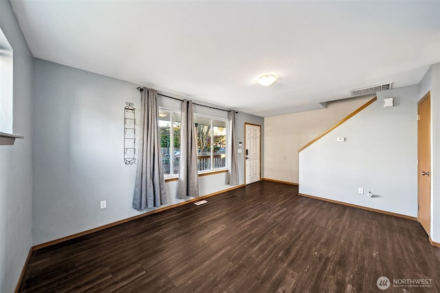 empty room with dark hardwood / wood-style flooring