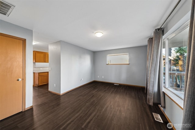 unfurnished room featuring dark hardwood / wood-style floors