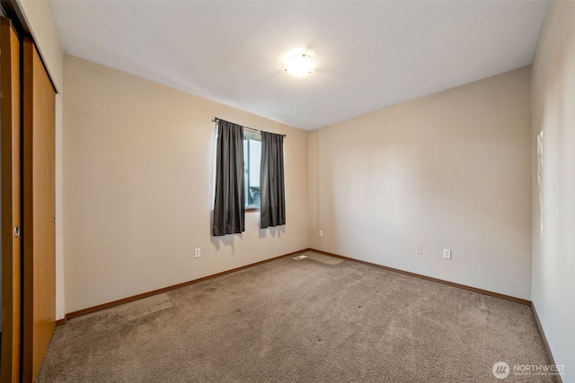 unfurnished bedroom with carpet floors and a closet