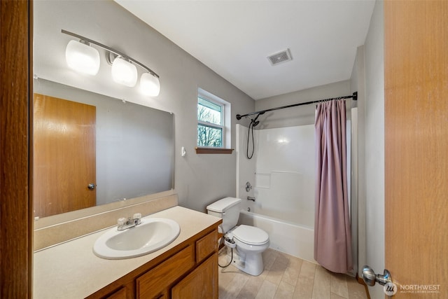 full bathroom with vanity, shower / bath combination with curtain, and toilet