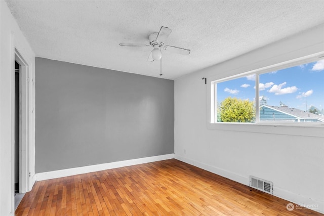 6309 S K St, Tacoma, WA 98408 - empty room featuring ceiling fan, wood-type flooring, and a textured ceiling