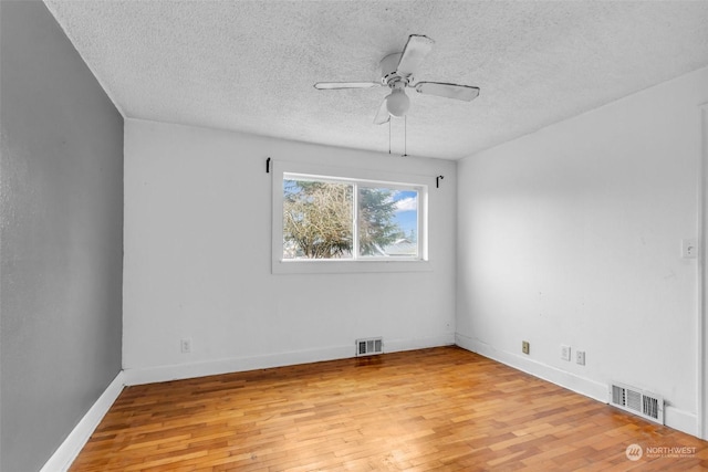 6309 S K St, Tacoma, WA 98408 - unfurnished room with ceiling fan, light hardwood / wood-style floors, and a textured ceiling