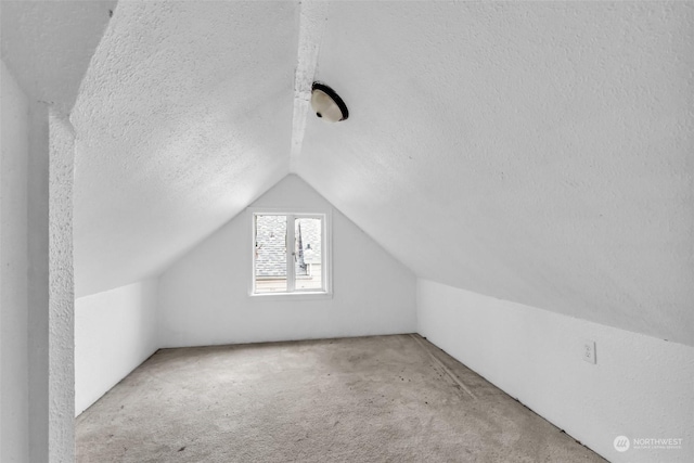 6309 S K St, Tacoma, WA 98408 - additional living space with vaulted ceiling, light carpet, and a textured ceiling