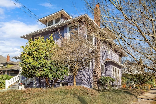 view of side of home with a yard