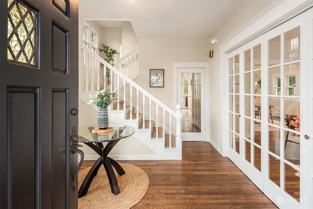 foyer featuring dark hardwood / wood-style floors and french doors