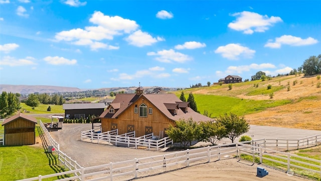 exterior space with a mountain view, a rural view, and an outdoor structure