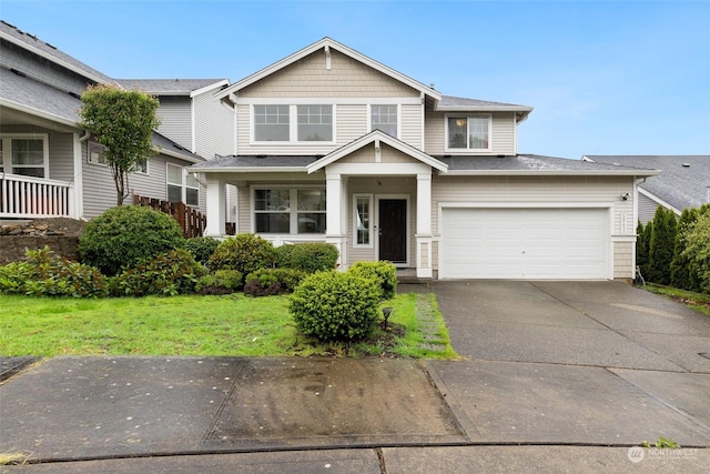 view of front of property with a garage and a front yard