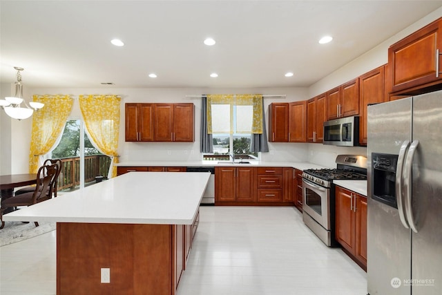20411 90th Pl S, Kent, WA 98031 - kitchen featuring a kitchen island, appliances with stainless steel finishes, pendant lighting, sink, and a chandelier