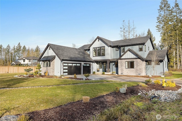 view of front of property with a garage, driveway, a front lawn, and fence