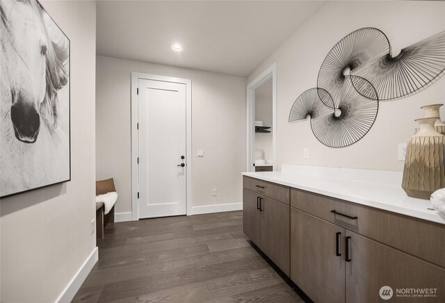 interior space with dark wood-style floors, recessed lighting, and baseboards