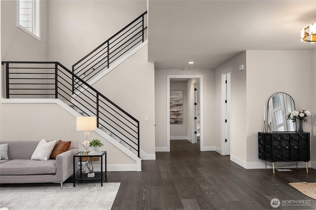 entrance foyer with recessed lighting, dark wood-style flooring, stairway, and baseboards