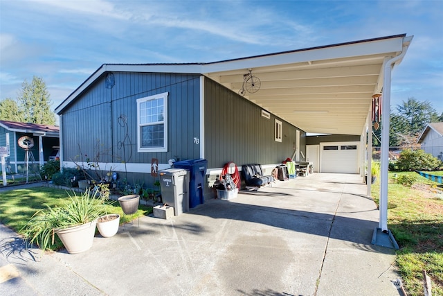 view of front of property with a carport, a garage, and a front lawn