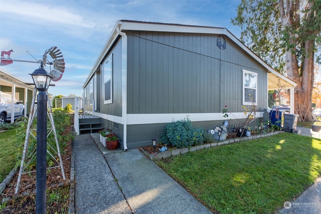 view of side of home featuring a yard