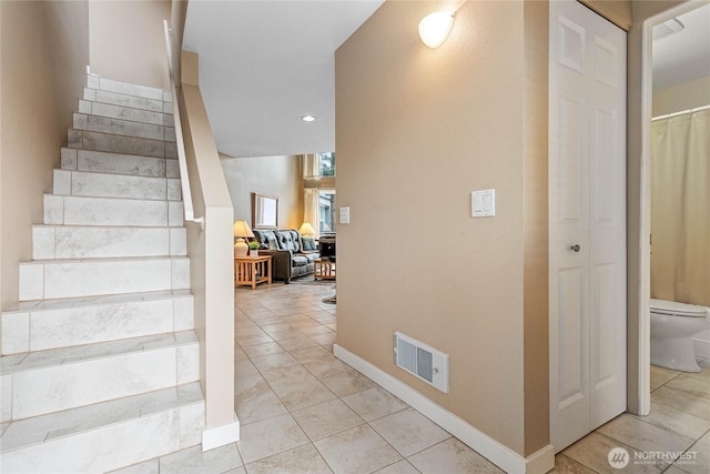 stairway with tile patterned flooring