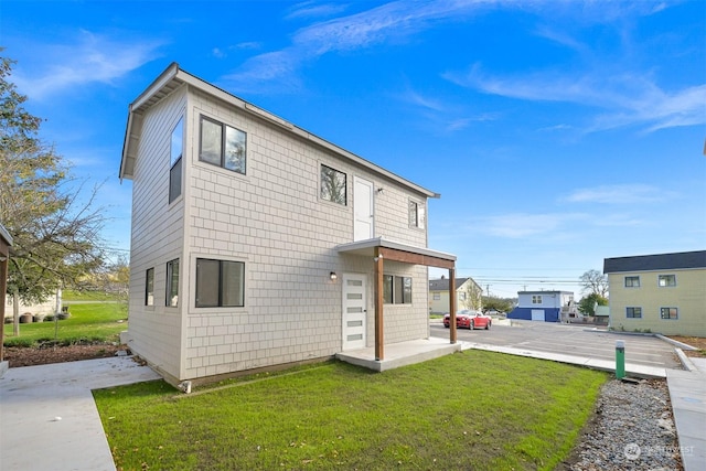 rear view of house featuring a yard